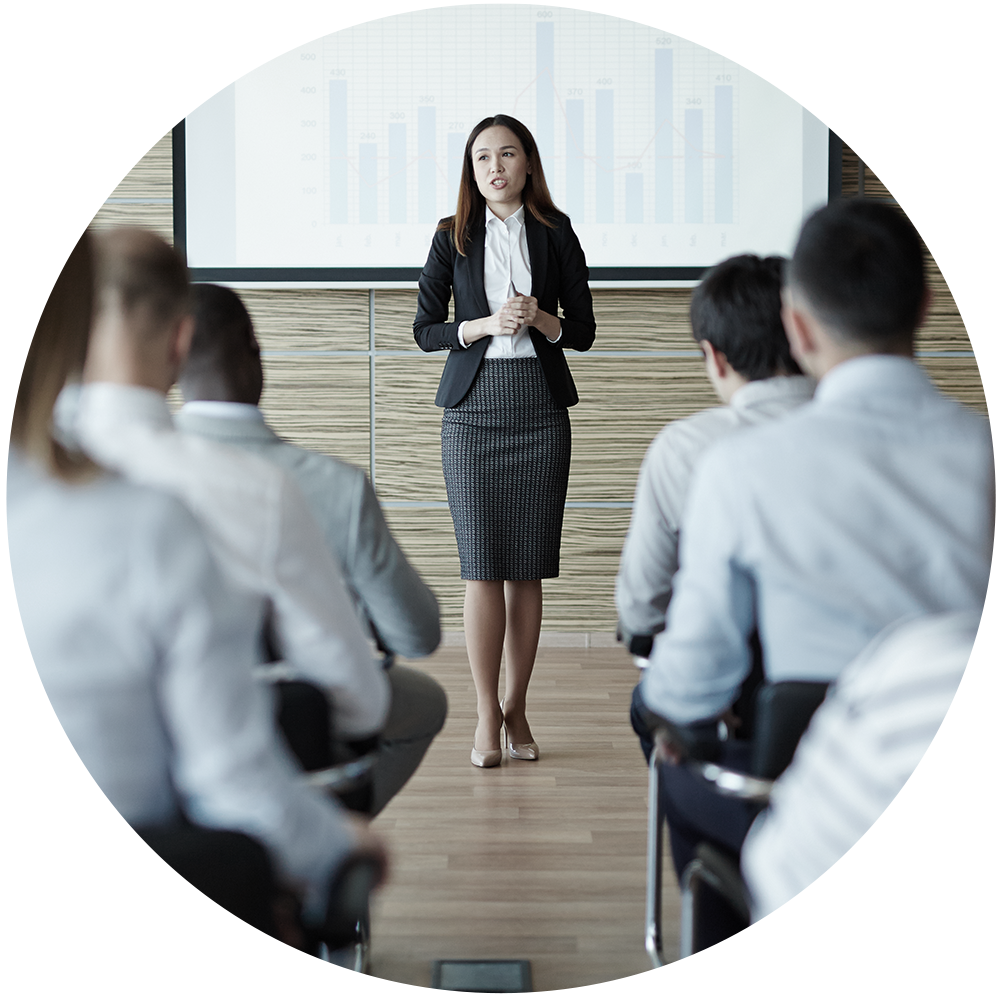 woman gives a presentation. Six people are watching her present.