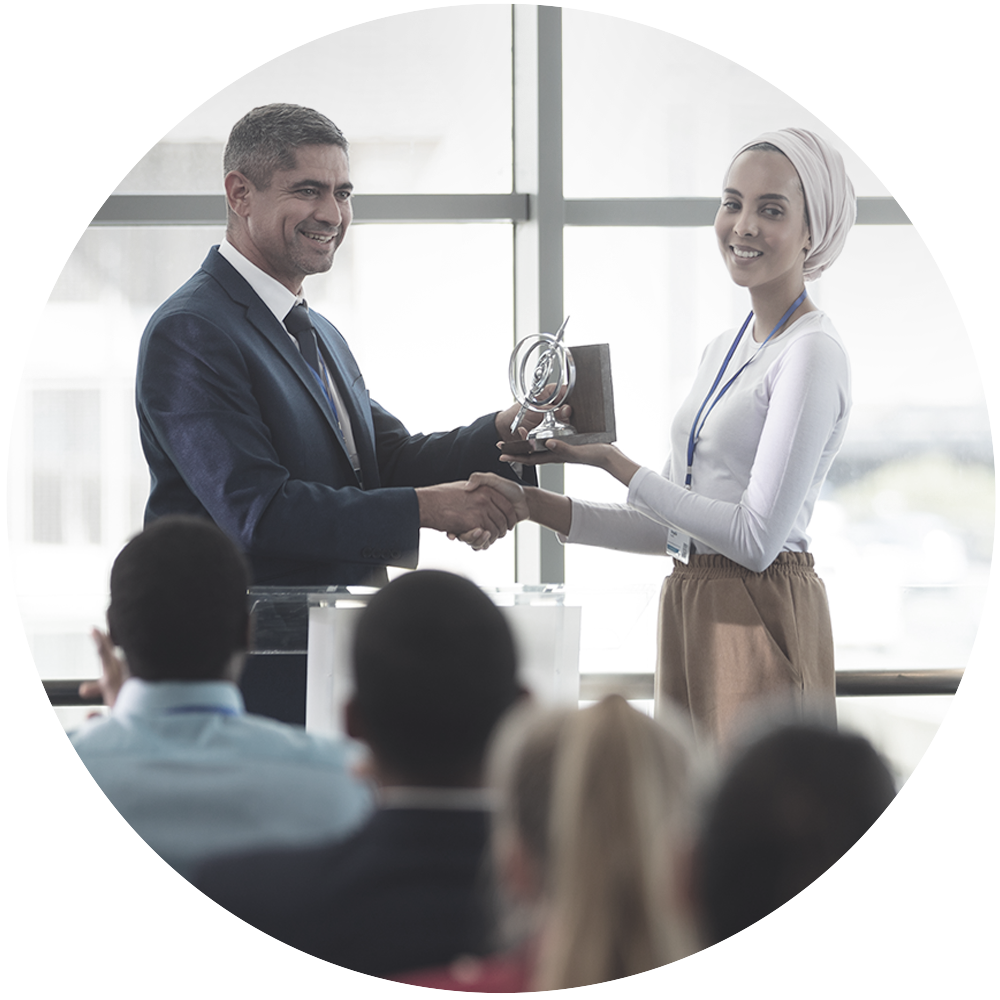 Man giving award to woman at a meeting