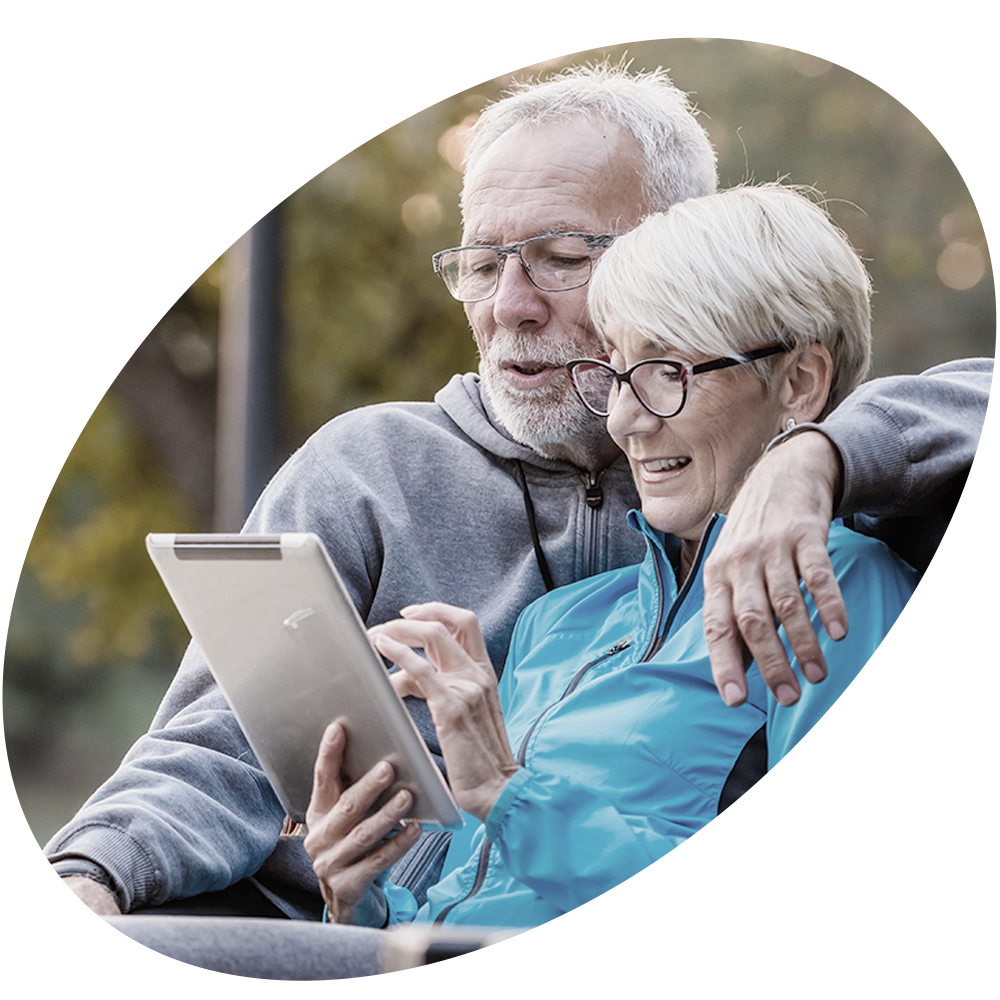Elderly couple looks at tablet