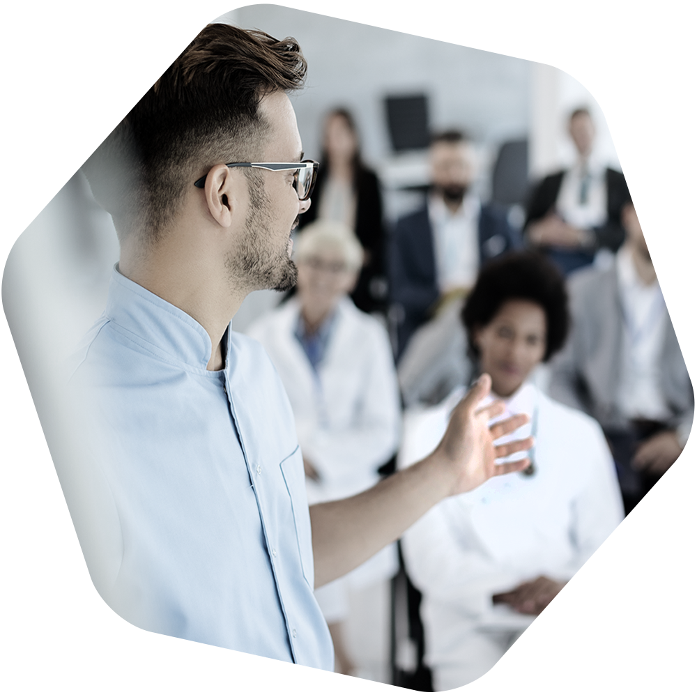 Man presenting to a room of healthcare professionals.