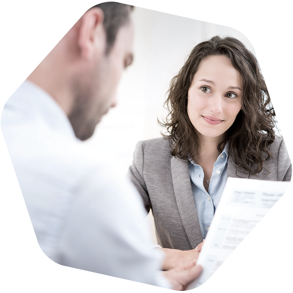 woman looks at man holding paper