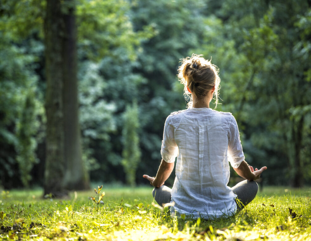 Woman meditating in a field