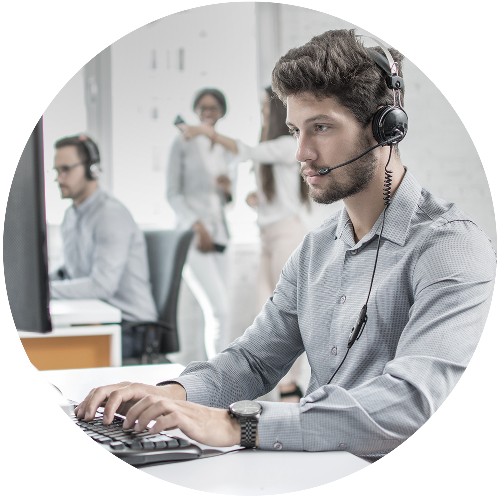 Man wearing headset typing at computer