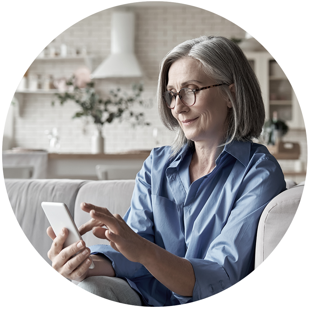 Woman sitting on couch looking at mobile phone