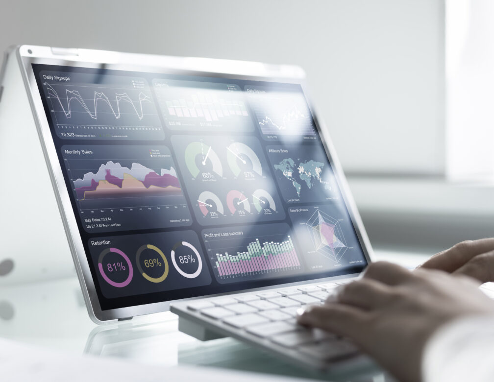 business person working on tablet with data charts on screen